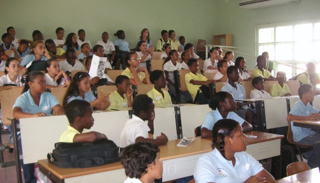Large group of Filomena Mavo College students seated in a lecture hall, attentively following a lesson or presentation.